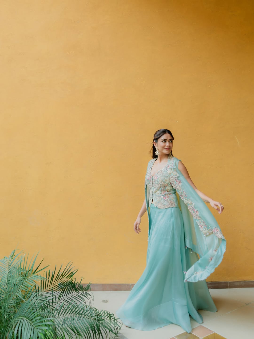 Mrunal Thakur posing elegantly in a stunning outfit at an event.