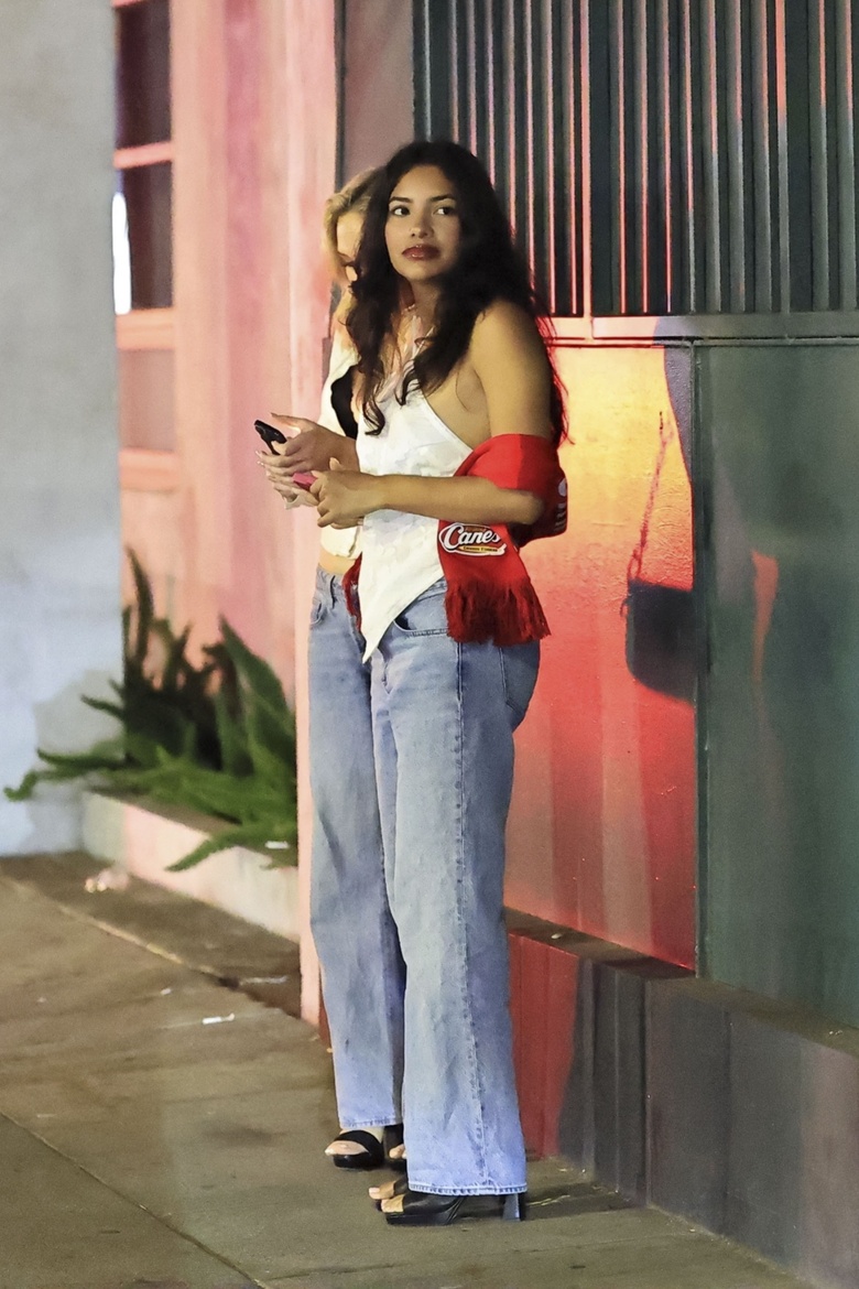 Natalie Alyn Lind posing confidently at an event, showcasing elegant attire.