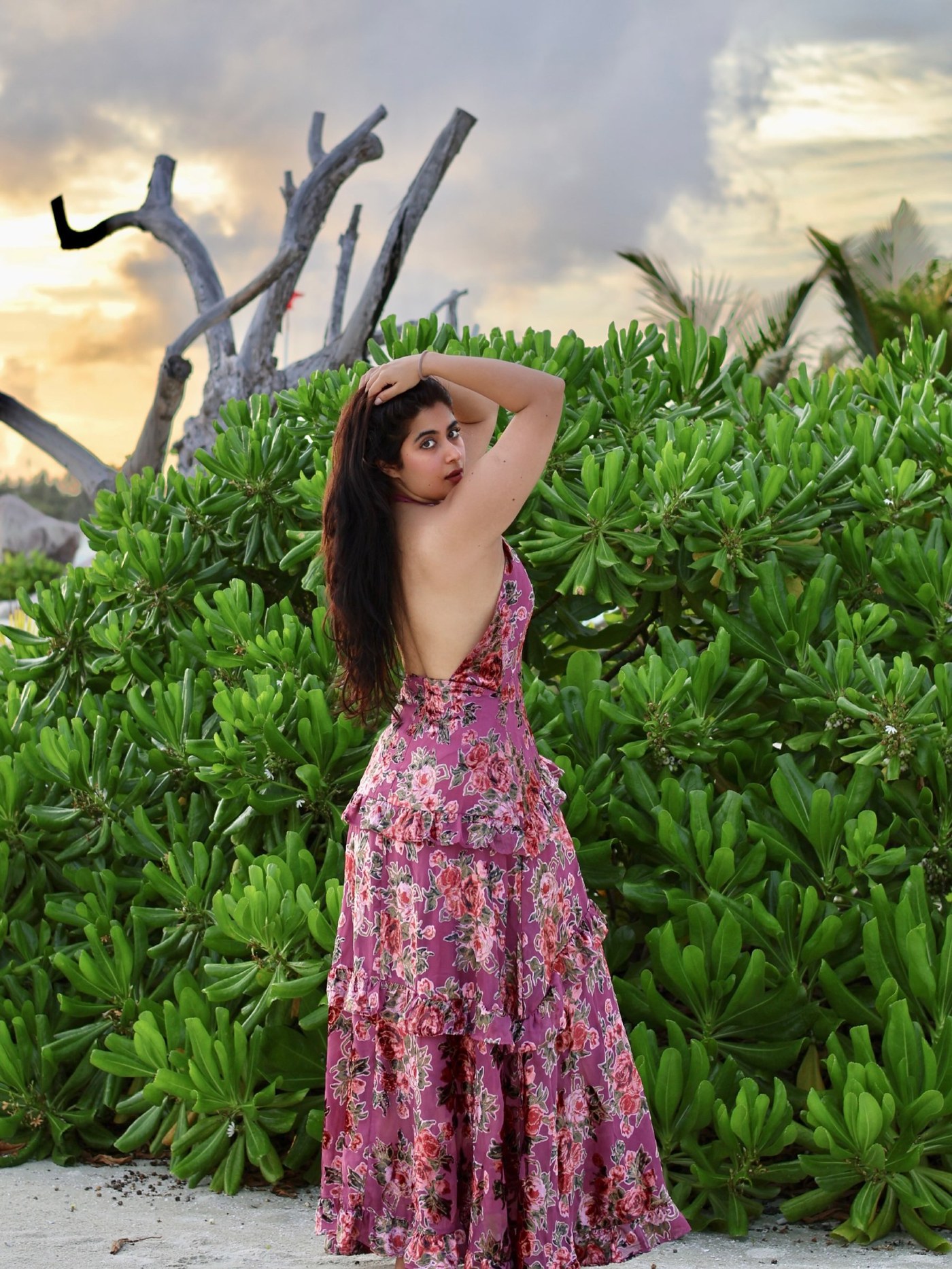 Nikita Sharma is captured in a breezy floral maxi dress against lush tropical Maldives scenery. - Photos & Updates