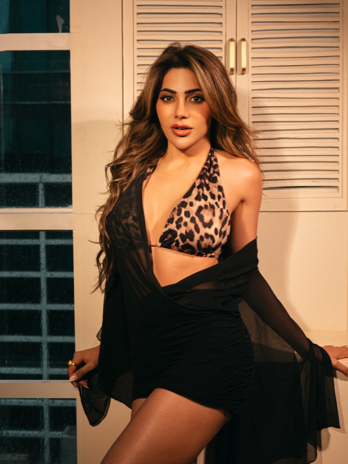 Nikki Tamboli showcases fierce glamour in a striking leopard-print bralette and mini skirt.