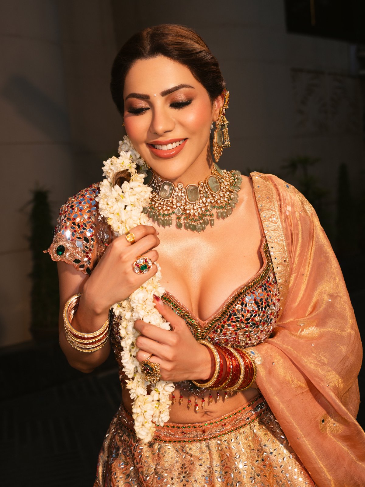 Peach Lehenga Paired With Green Stone Jewellery