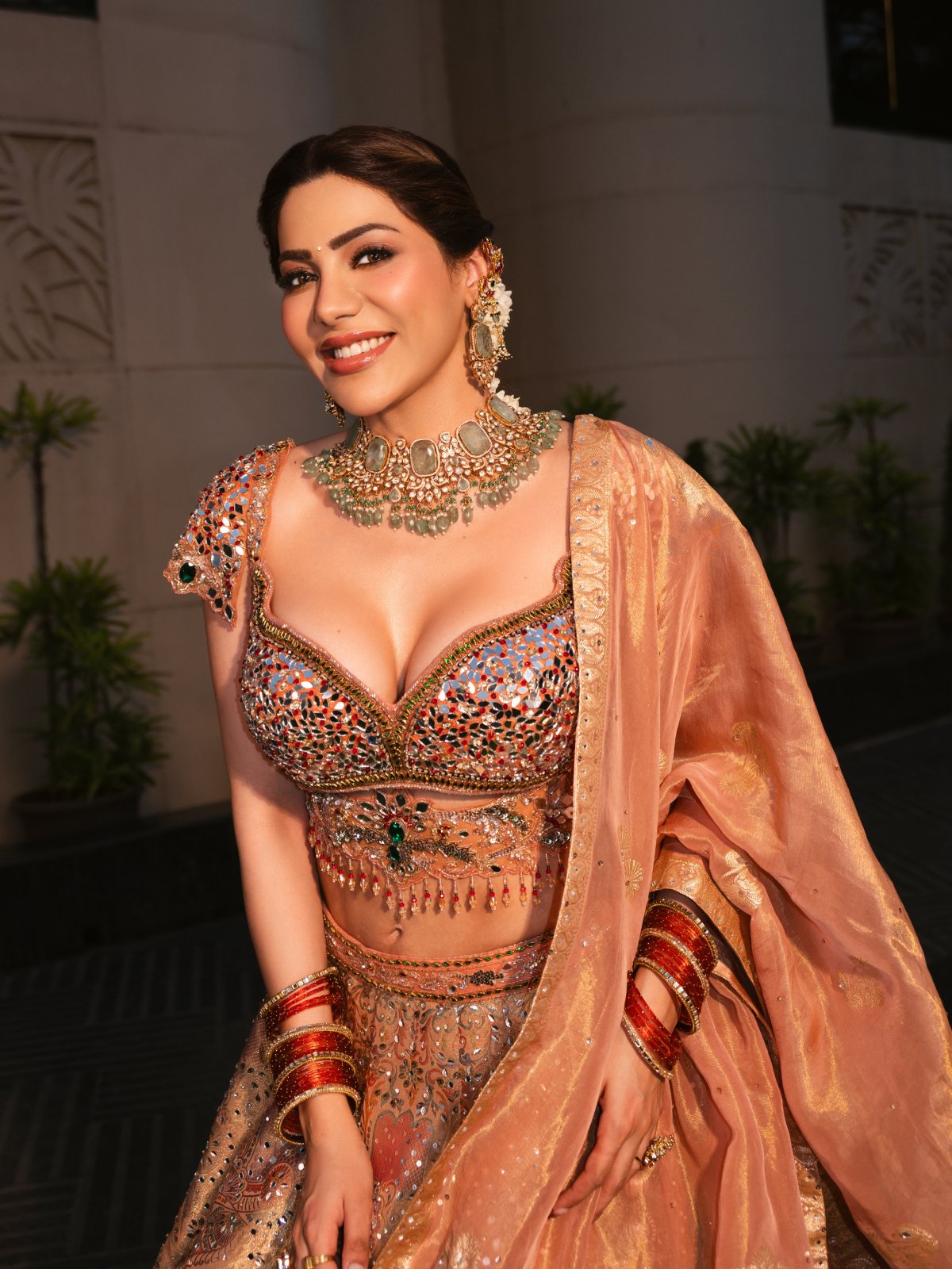 Peach Lehenga Paired With Green Stone Jewellery