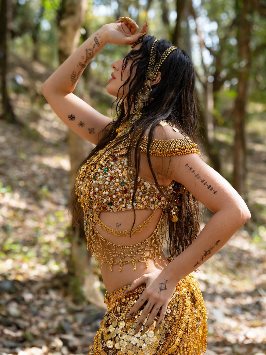 Nora Fatehi's Golden Glamour: Water and Wonder Shots