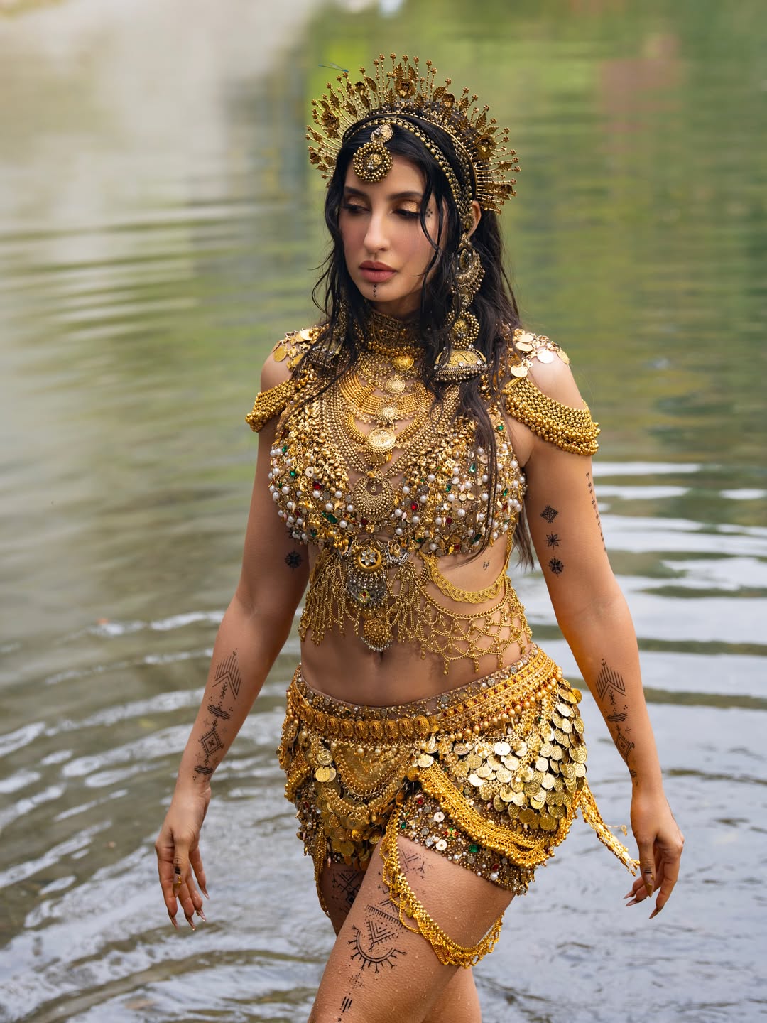 Nora Fatehi's Golden Glamour: Water and Wonder Shots
