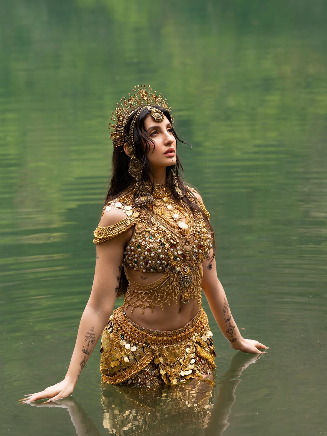 Nora Fatehi's Golden Glamour: Water and Wonder Shots