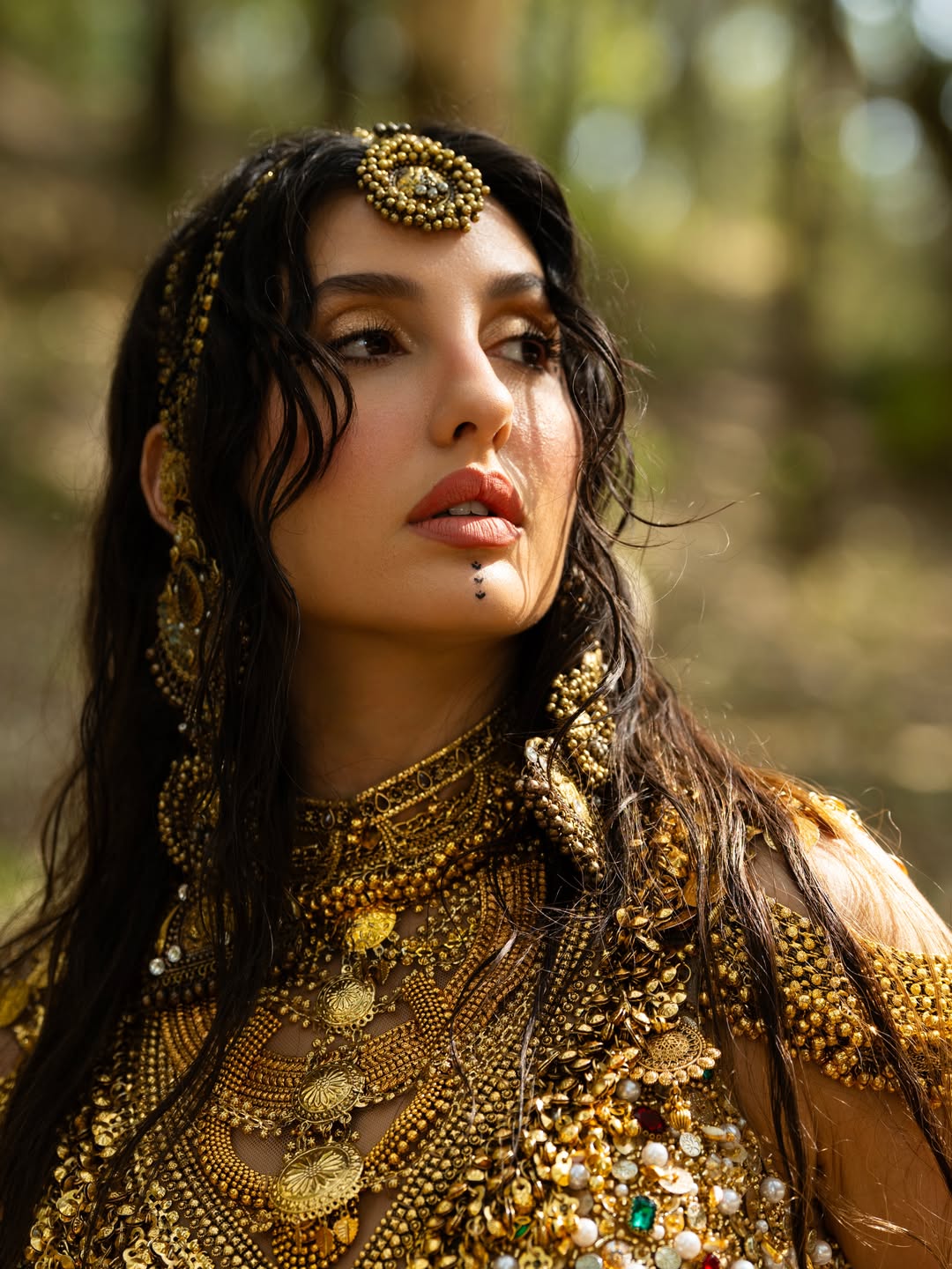 Nora Fatehi's Golden Glamour: Water and Wonder Shots