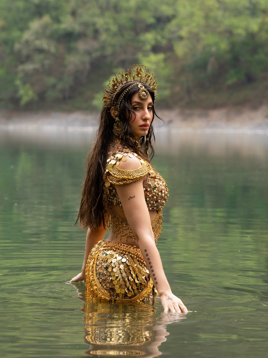 Nora Fatehi's Golden Glamour: Water and Wonder Shots