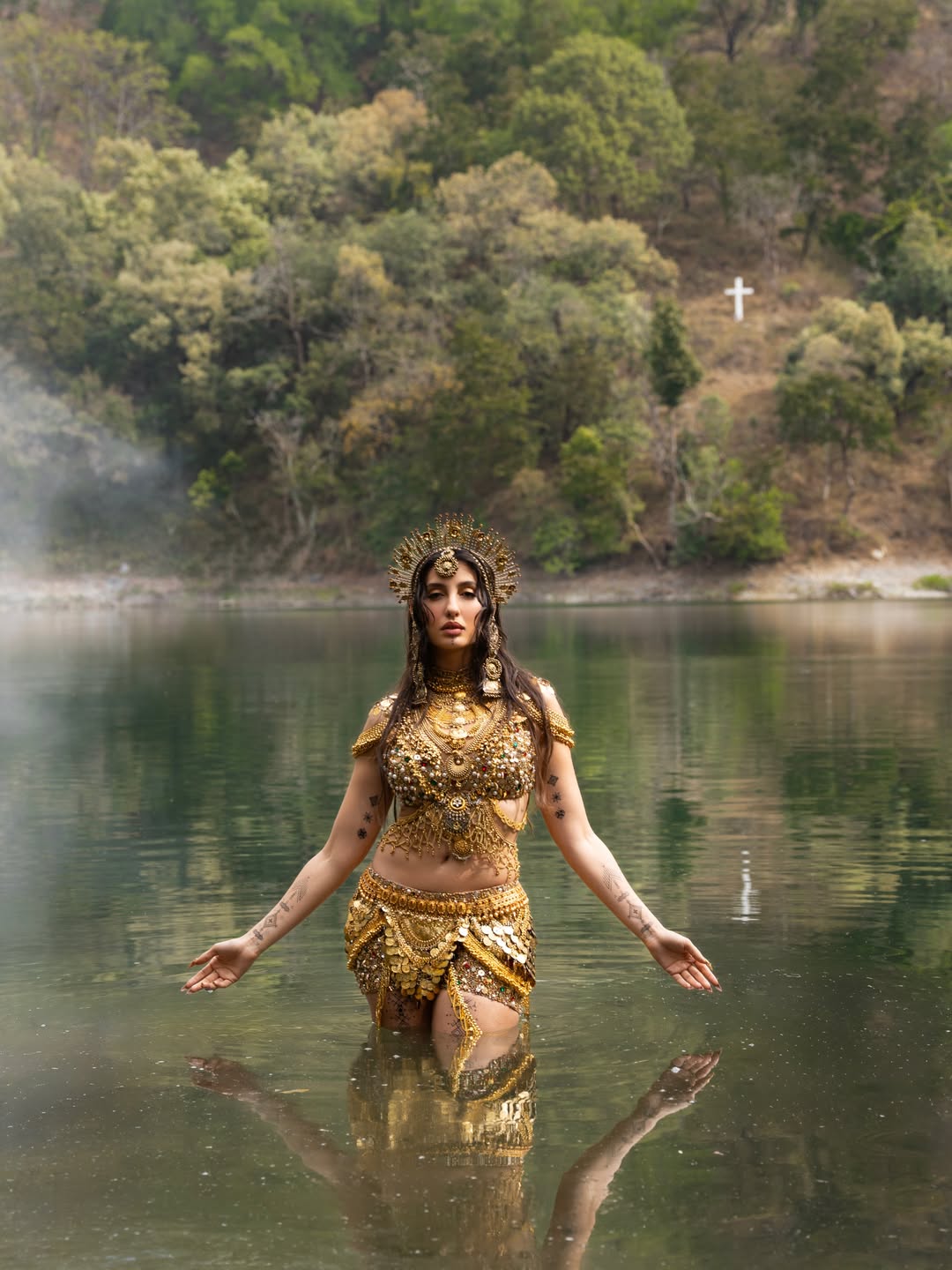 Nora Fatehi's Golden Glamour: Water and Wonder Shots