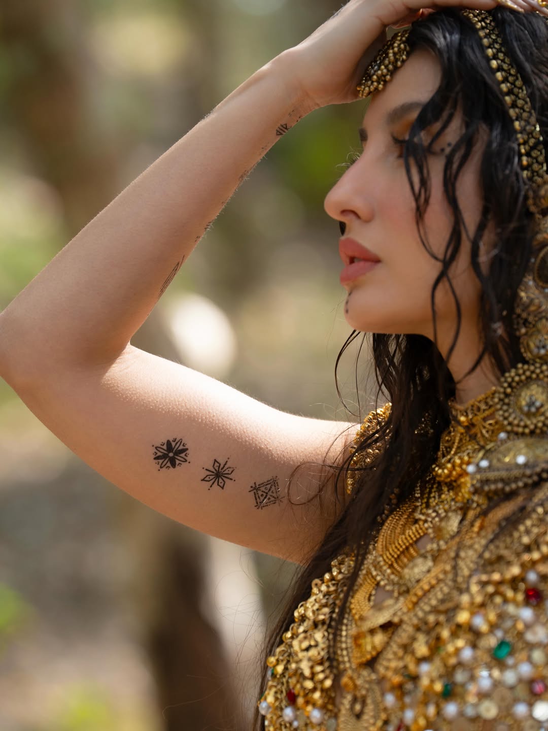Nora Fatehi's Golden Glamour: Water and Wonder Shots
