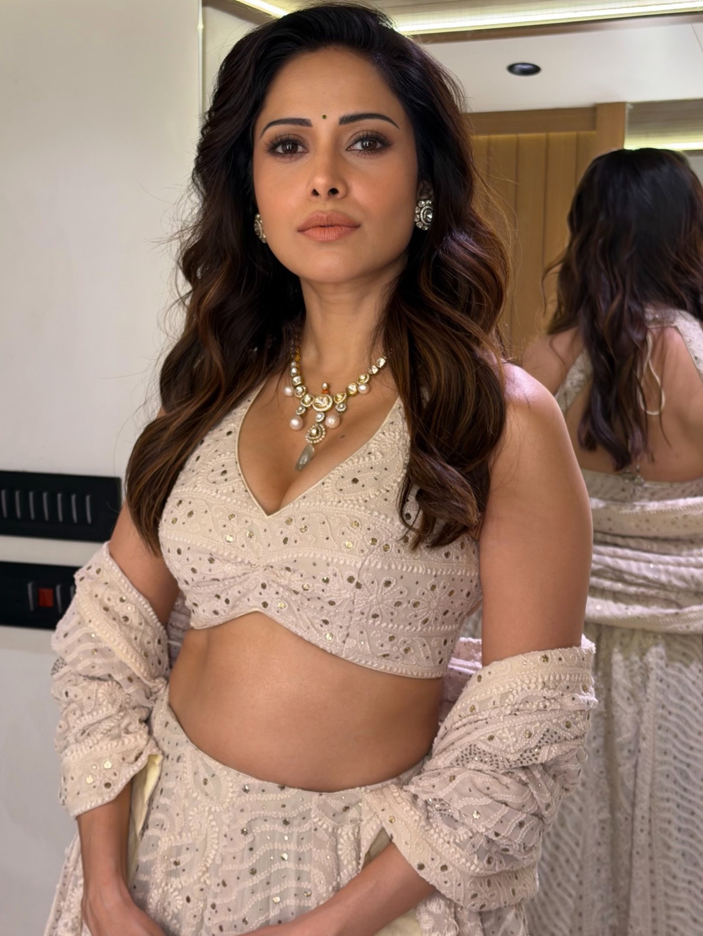 Nushrratt Bharuccha showcases a striking traditional ensemble in muted beige tones, embodying contemporary Indian elegance. - Photos & Updates