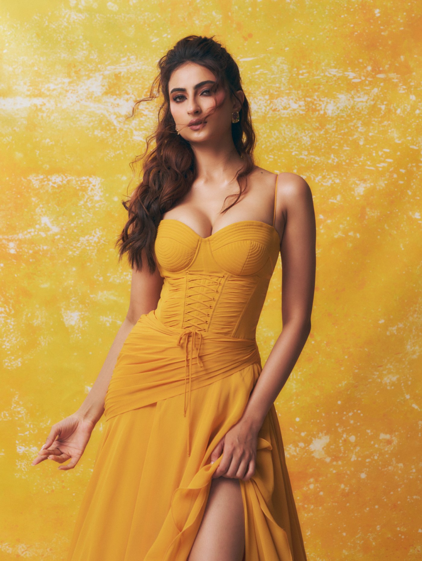 Palak Tiwari in a sculpted, golden-yellow gown against a matching backdrop. - Photos & Updates