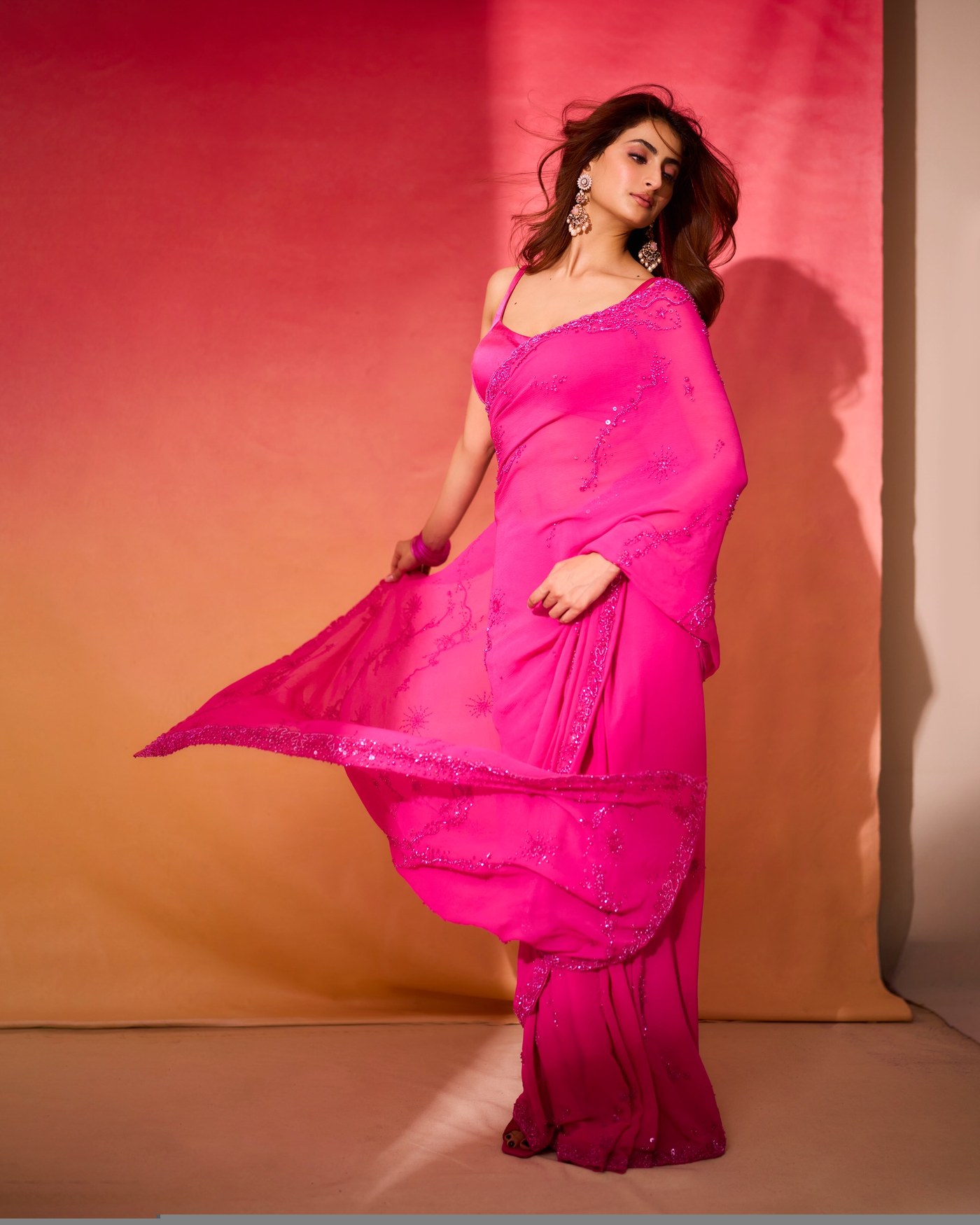 Palak Tiwari showcases a vivid fuchsia ensemble against a warm coral backdrop. - Photos & Updates
