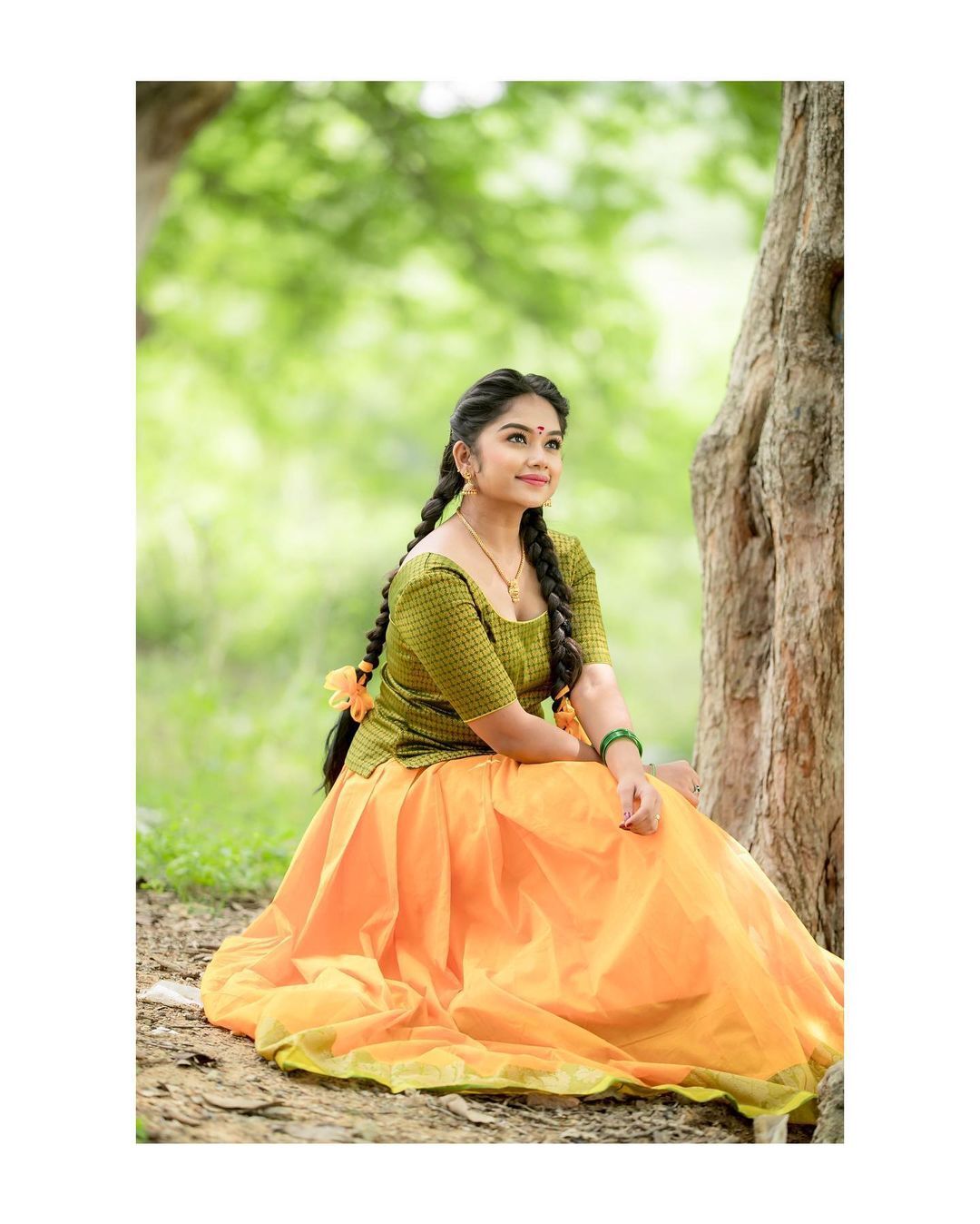 Preethi Sharma draped in deep magenta fabric with a dark garment underneath, showing a soft expression.