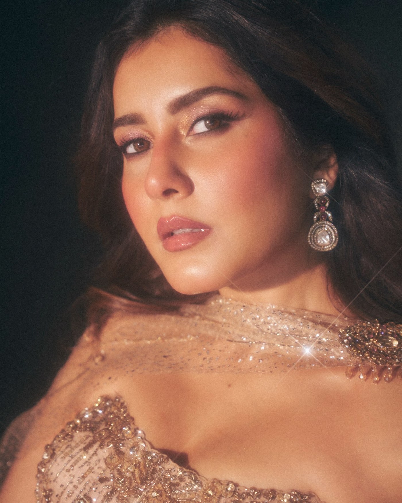 Raashii Khanna radiates sophistication in an intricately embellished golden gown and sheer cape.