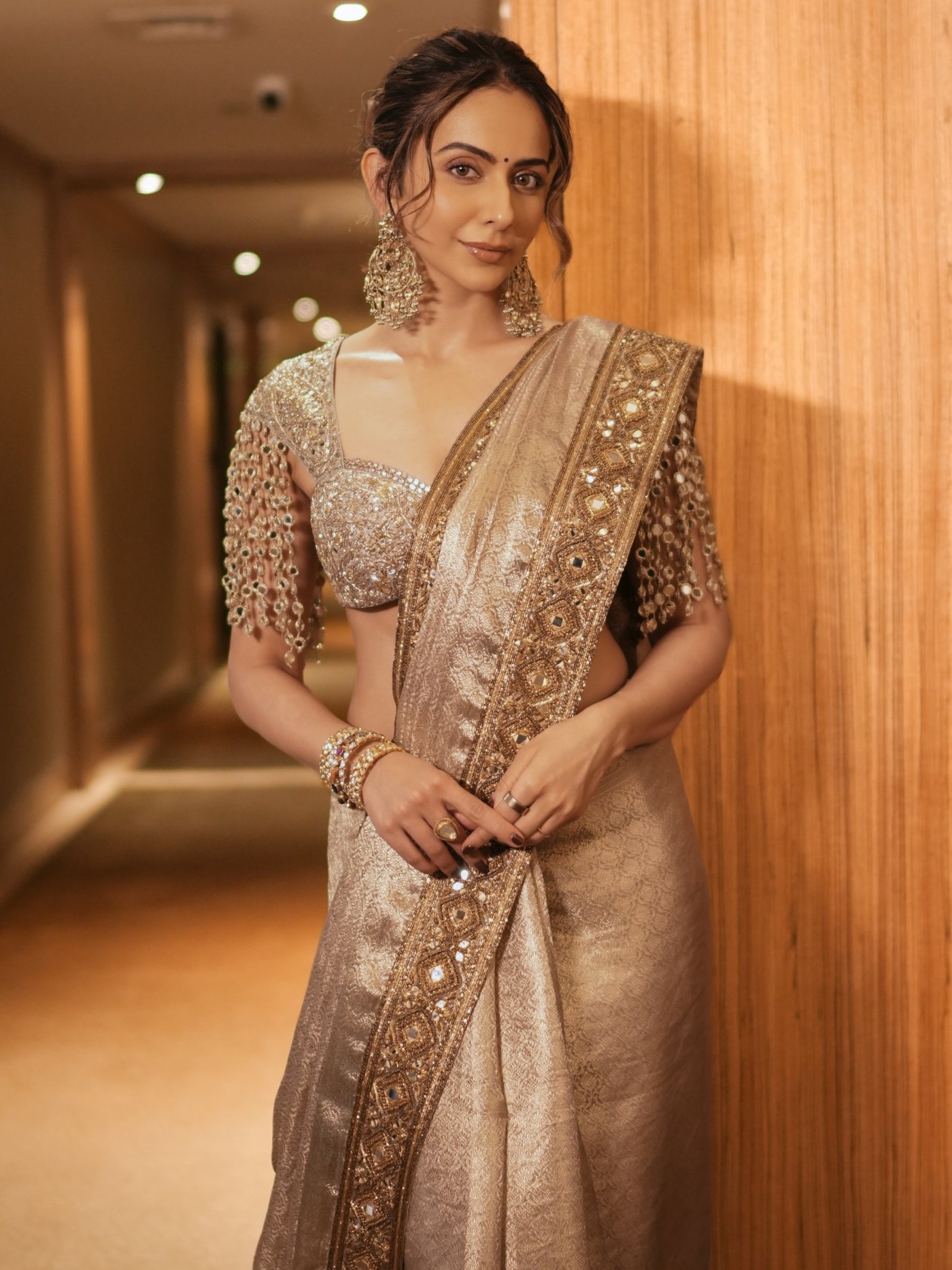Rakul Preet Singh in a champagne-gold sari with detailed embellishment.