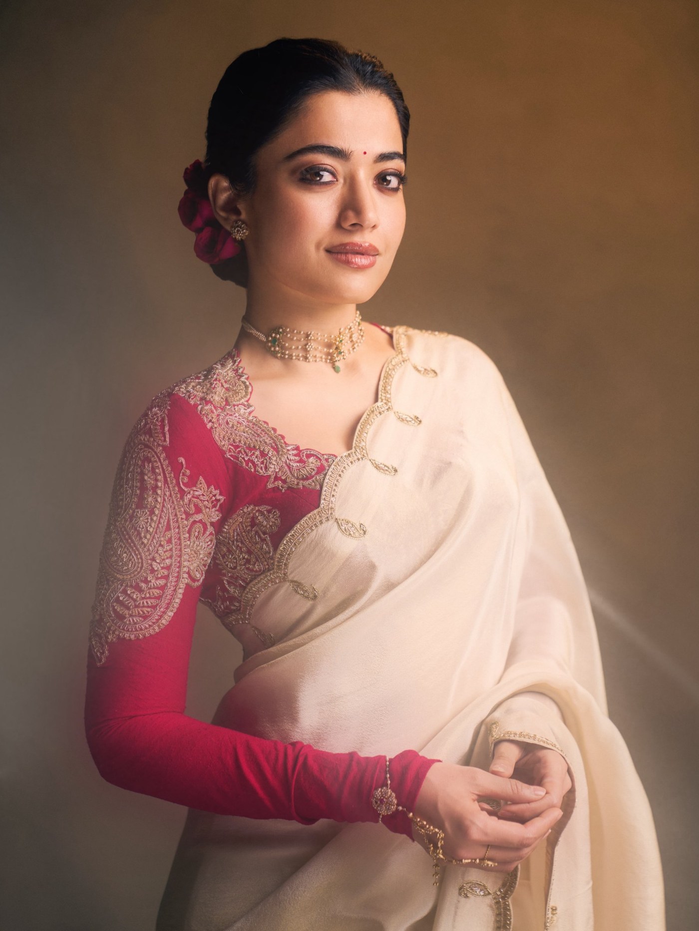 Ivory Drape Meets Ruby Red: Rashmika’s Festive Statement