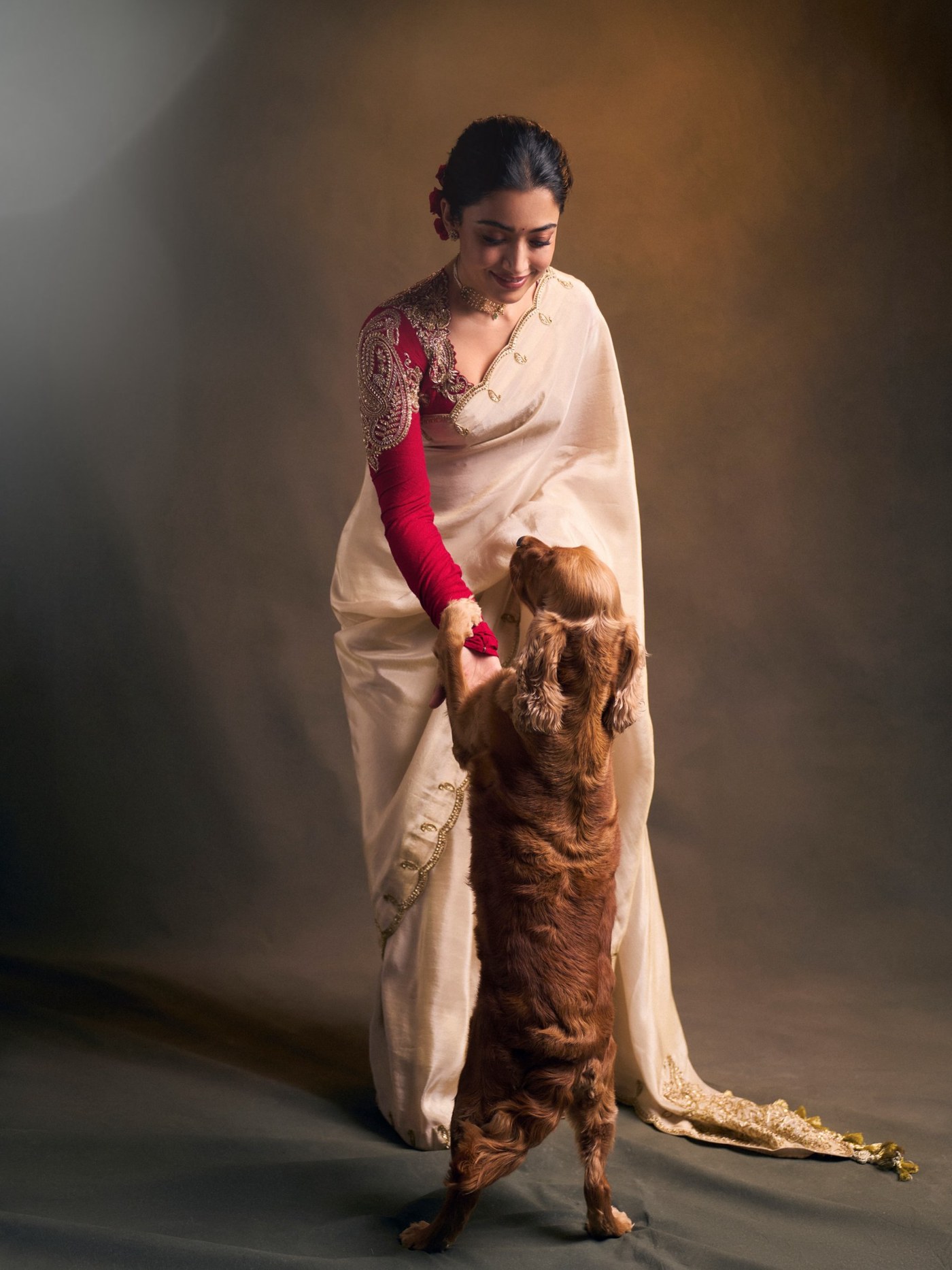 Ivory Drape Meets Ruby Red: Rashmika’s Festive Statement