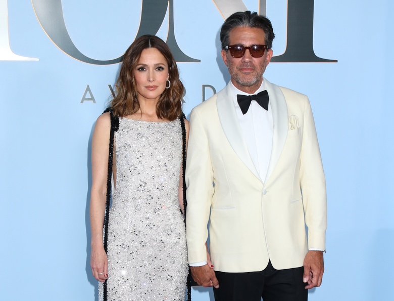 Rose Byrne posing elegantly at an upscale gathering, showcasing a vibrant and stylish ensemble.