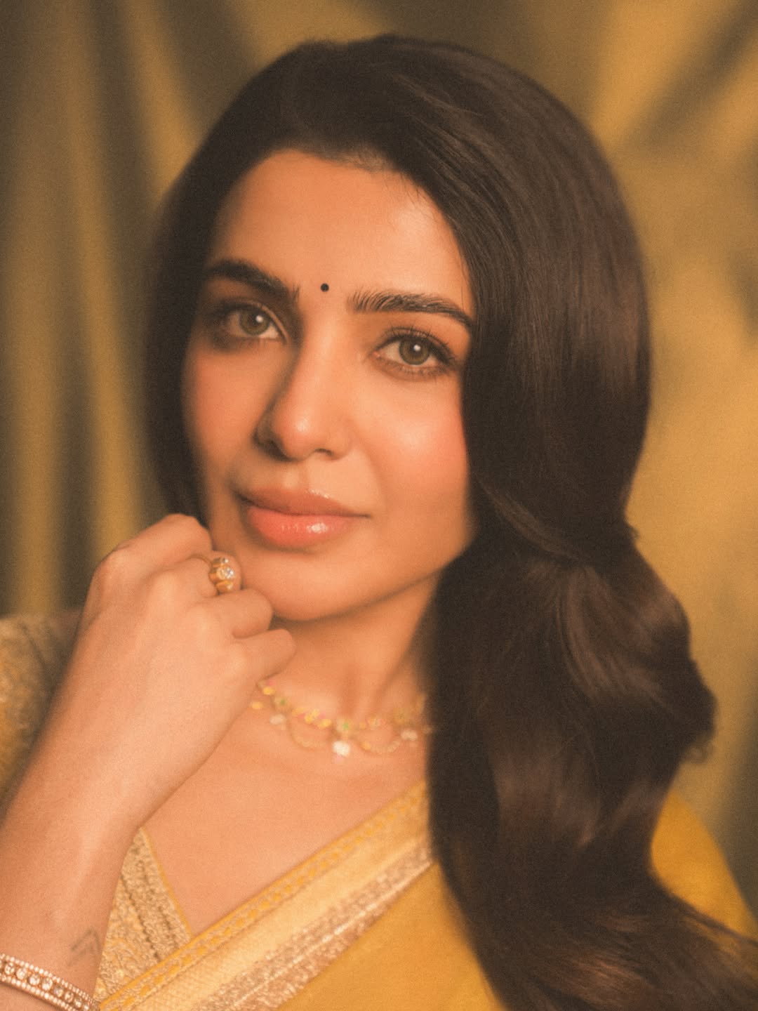 Samantha Ruth Prabhu is captured showcasing a vibrant yellow saree, radiating timeless grace and confidence.