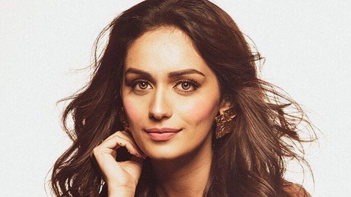 Manushi Chhillar poses looking elegant and poised in a full-length outfit.