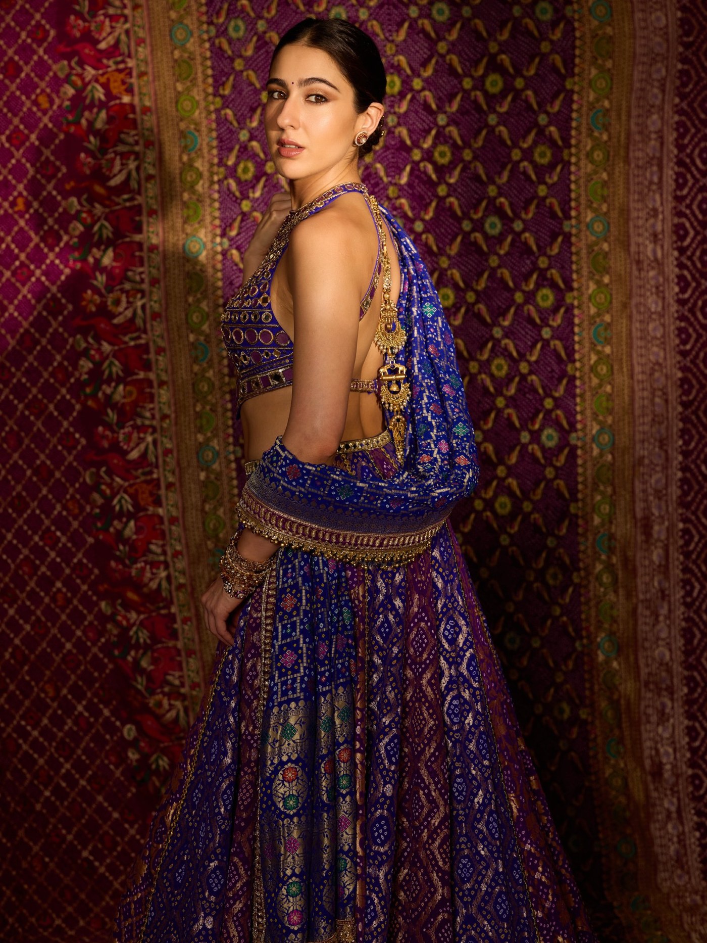 Sara Ali Khan showcases a richly patterned blue and gold lehenga ensemble. - Photos & Updates