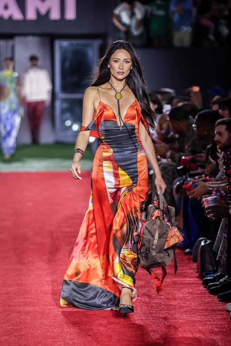 Shay Mitchell is seen shining brightly on a glamorous red carpet, looking chic and poised.
