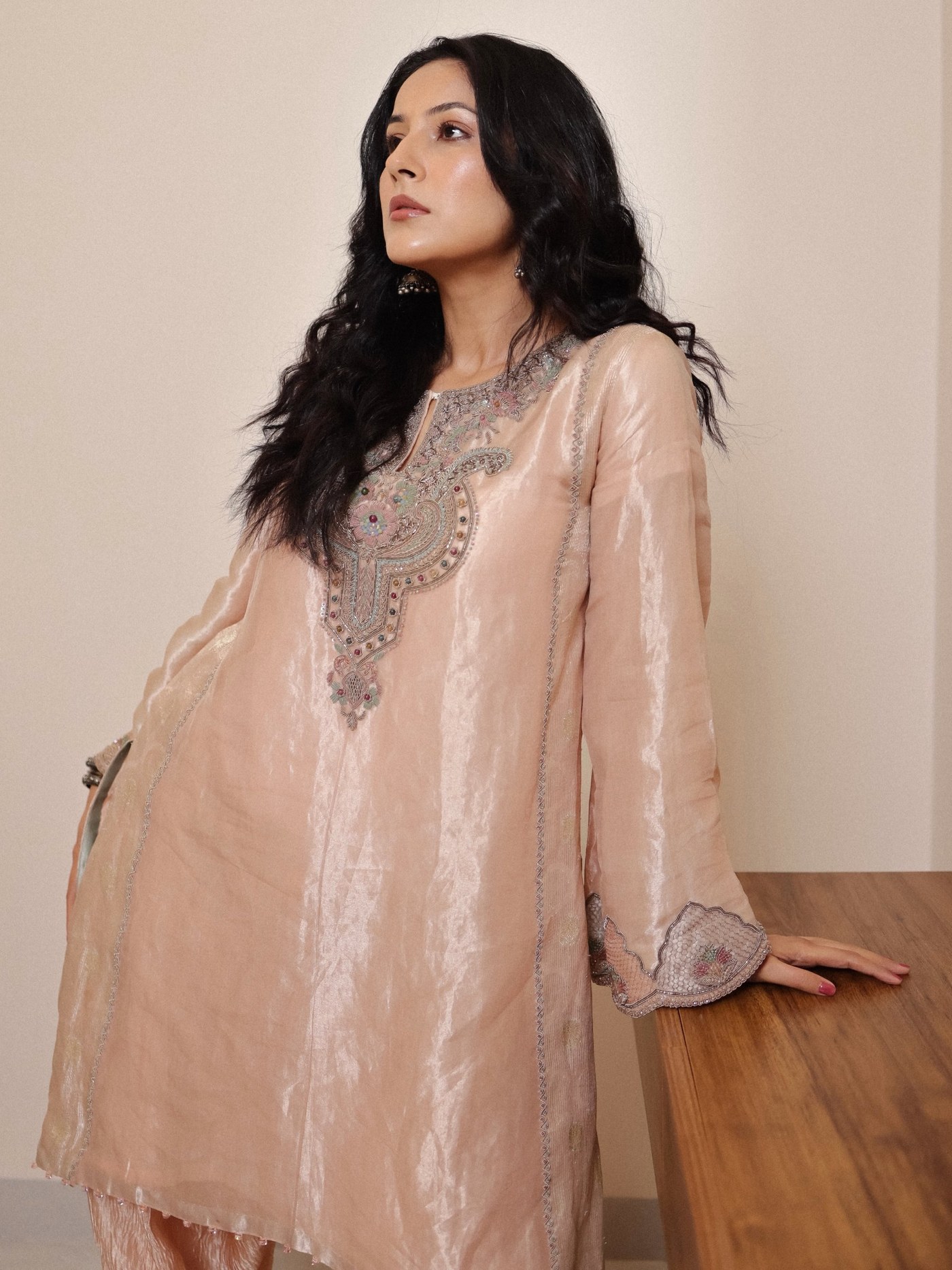 Shehnaaz Gill poses in a striking pose, showcasing her confident and versatile style at a public event.