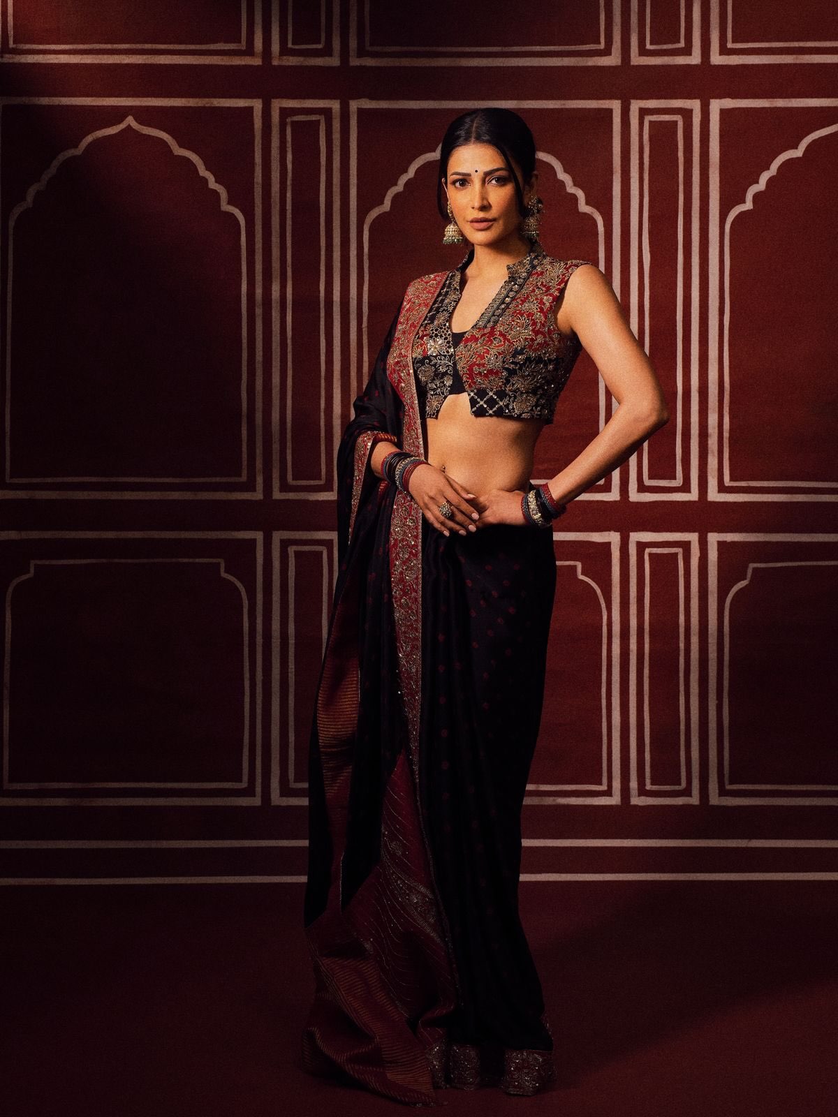 Shruti Haasan in a black sari accented with crimson and gold detailing. - Photos & Updates