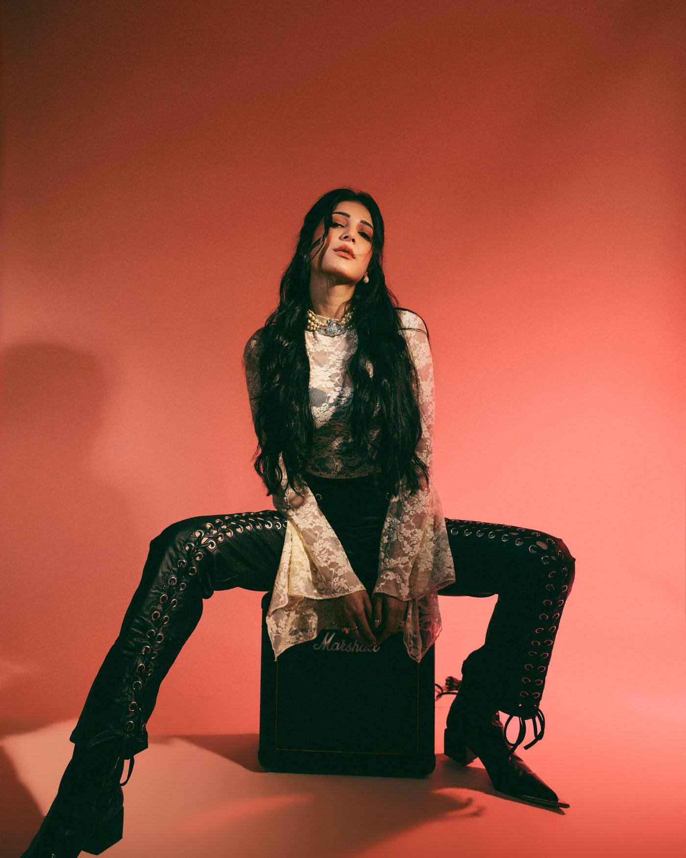 Shruti Haasan is pictured showcasing a rock ’n’ roll inspired look featuring delicate lace and structured leather.