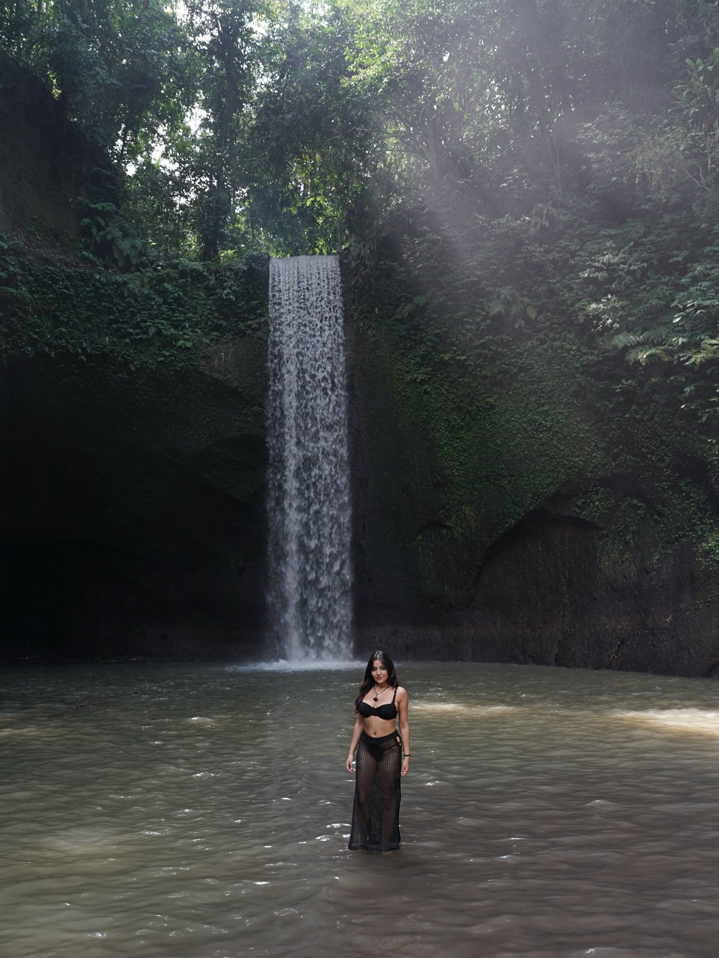 Simran Kaur is captured amidst lush greenery and cascading waterfalls, embodying natural elegance and bold style.