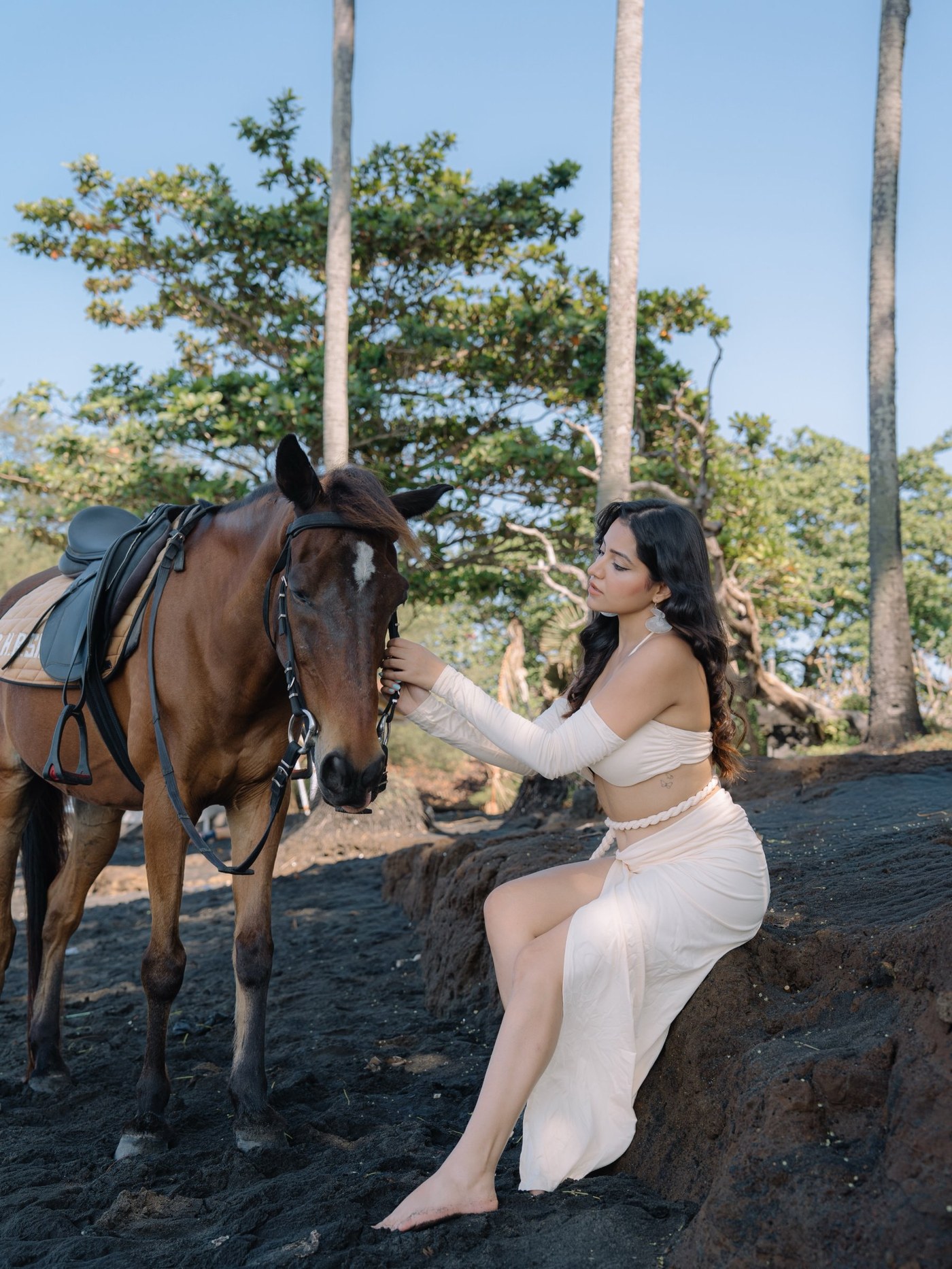 Simran Kaur models an effortlessly elegant outfit against a beautiful, serene coastline backdrop. - Photos & Updates