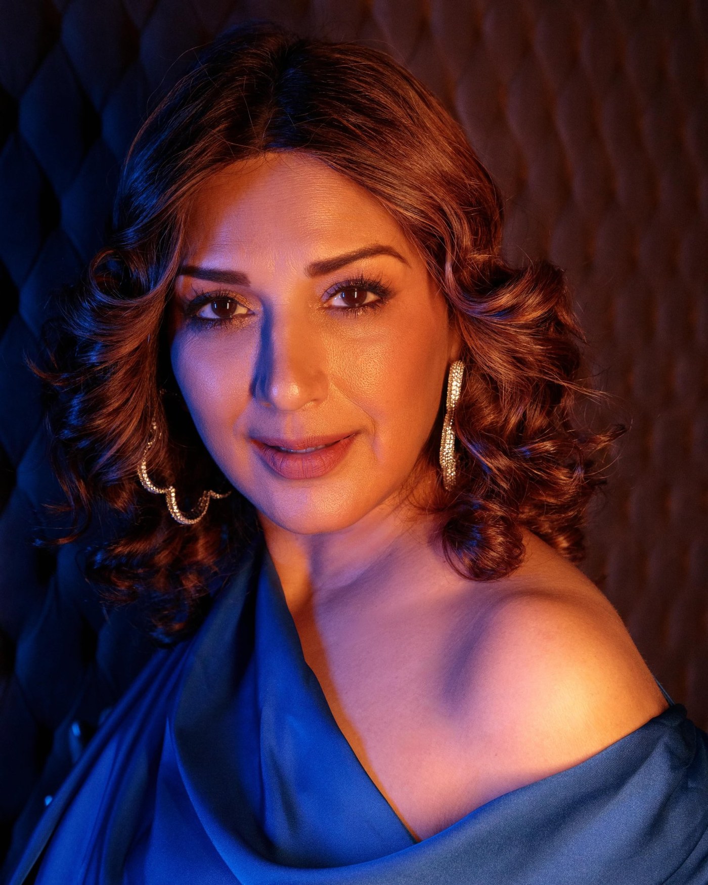 Sonali Bendre showcases a regal fashion statement in a luxurious royal blue saree, embracing traditional elegance with modern flair.