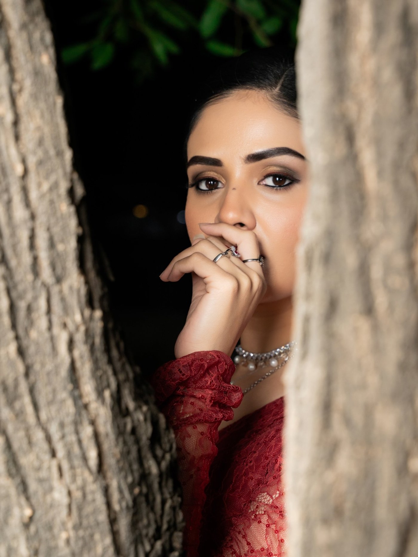 Sreemukhi shines in a rich red ensemble featuring luxurious textures and graceful detailing at a public event.