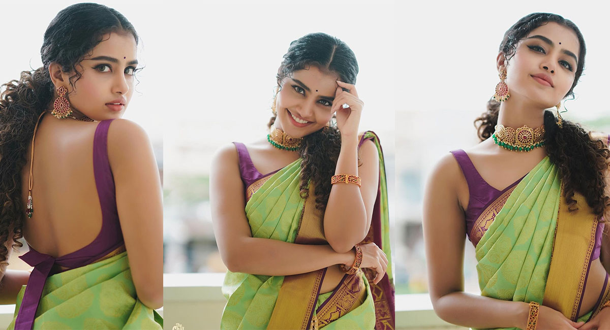 Anupama Parameswaran posing in a portrait featuring flowing lime green attire and ornate gold jewelry.