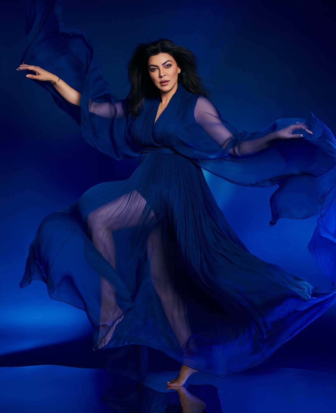 Sushmita Sen poses elegantly on a red carpet, showcasing her timeless beauty and grace.