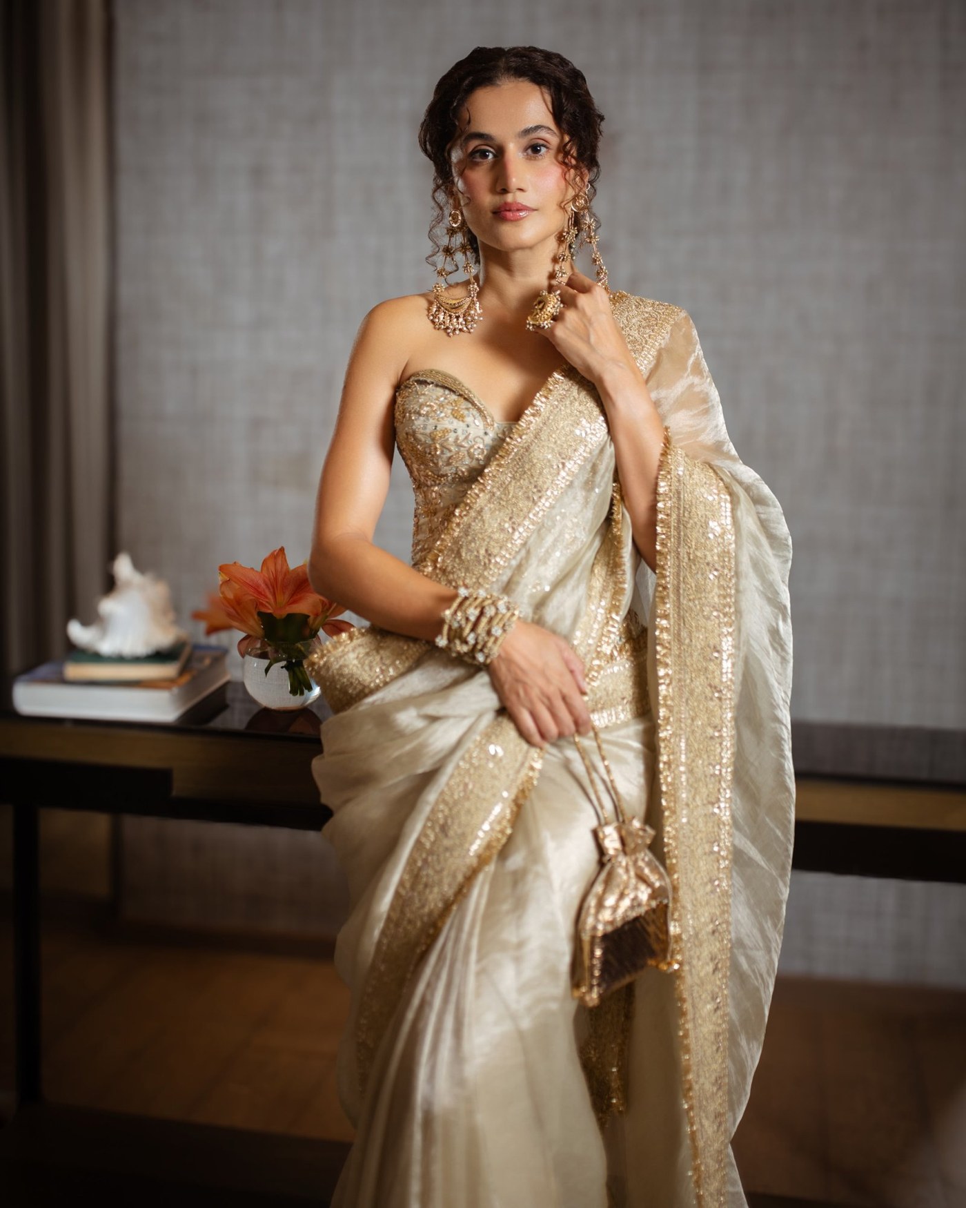 Taapsee Pannu showcases an ivory and gold sari look with intricate embellishment. - Photos & Updates