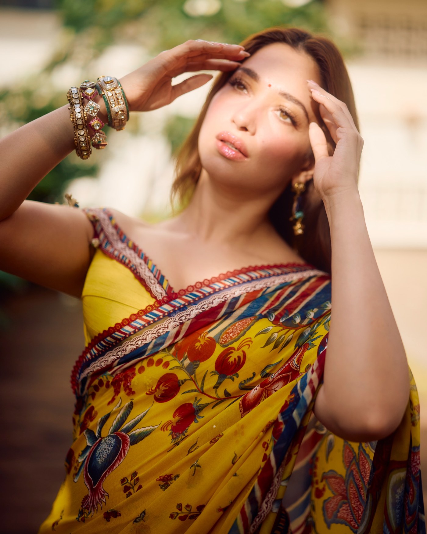 Tamannaah Bhatia wears a vibrant yellow Torani saree featuring floral and paisley motifs at The Vvaan trailer launch.