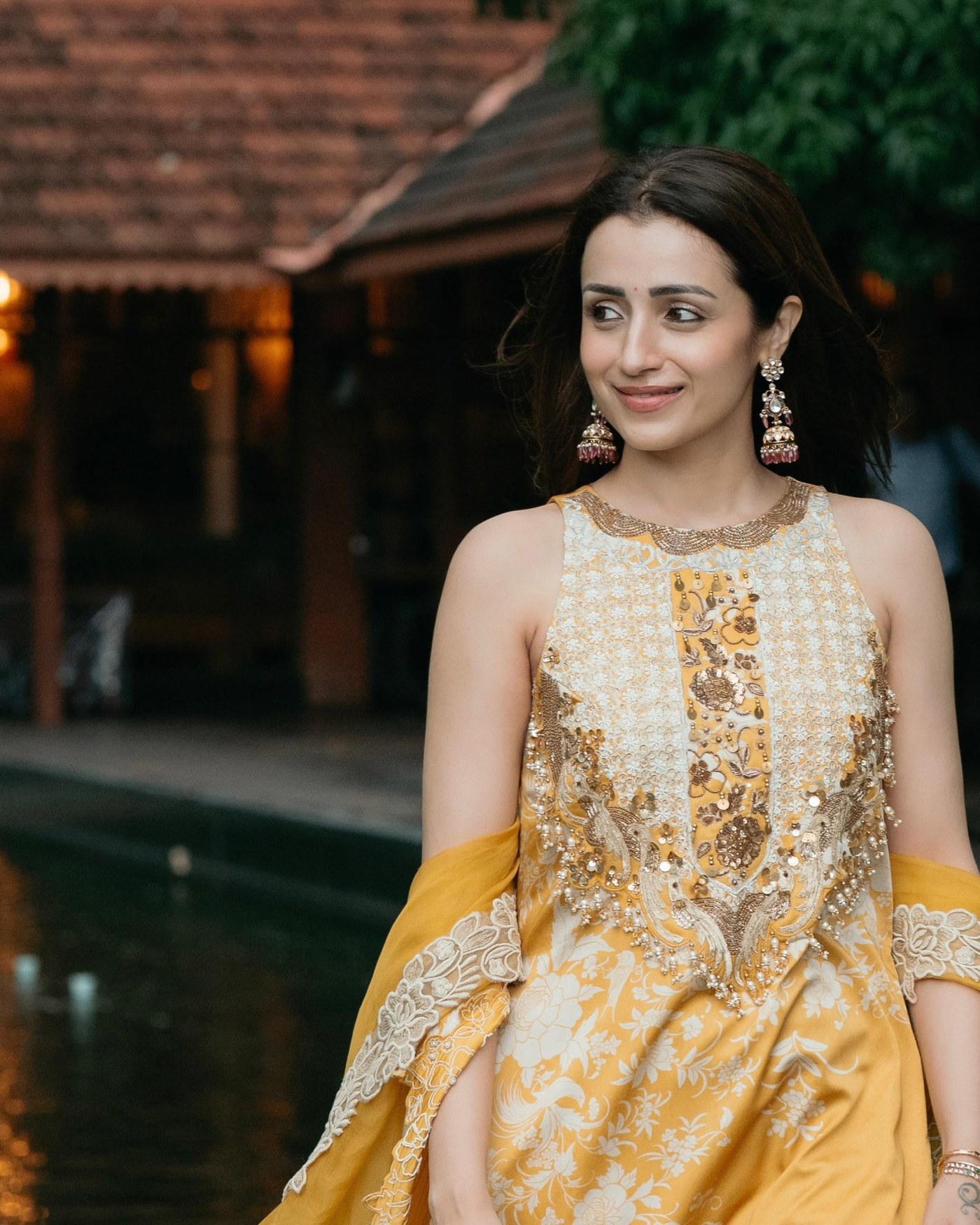 Trisha Krishnan shines in regal yellow, showcasing beautifully embroidered ethnic fashion.