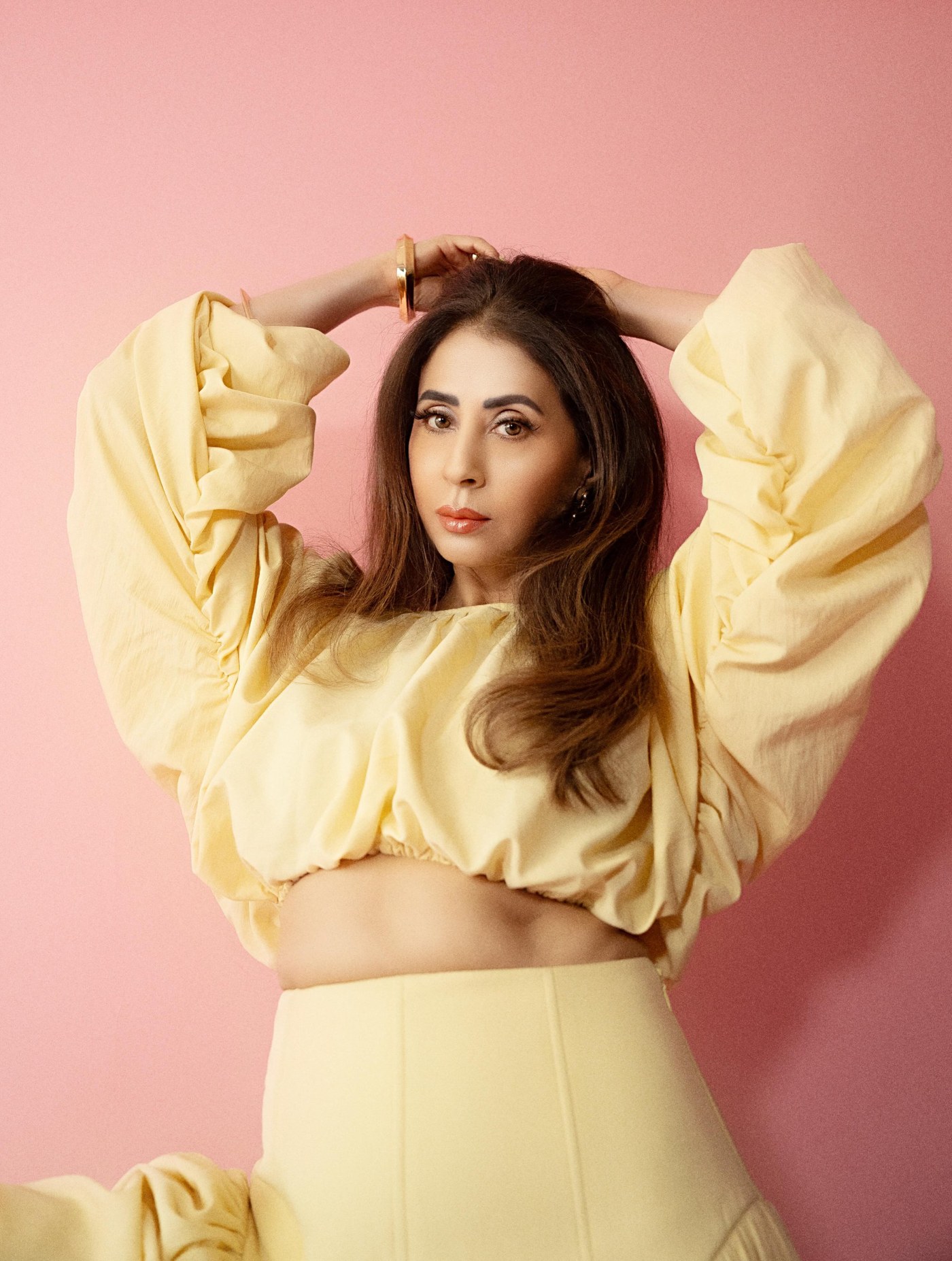 Urmila Matondkar showcases a dreamy, flowing pastel yellow outfit with voluminous sleeves.
