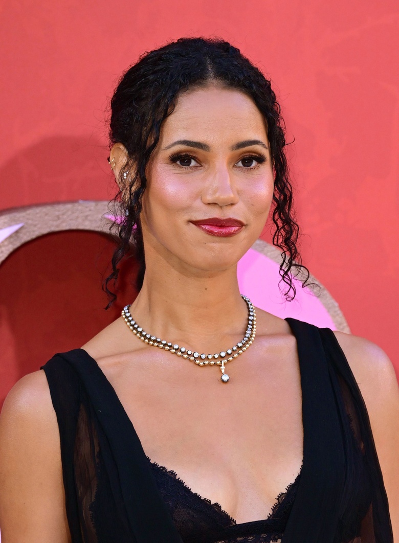 Vick Hope posing in a vibrant outfit at an event.
